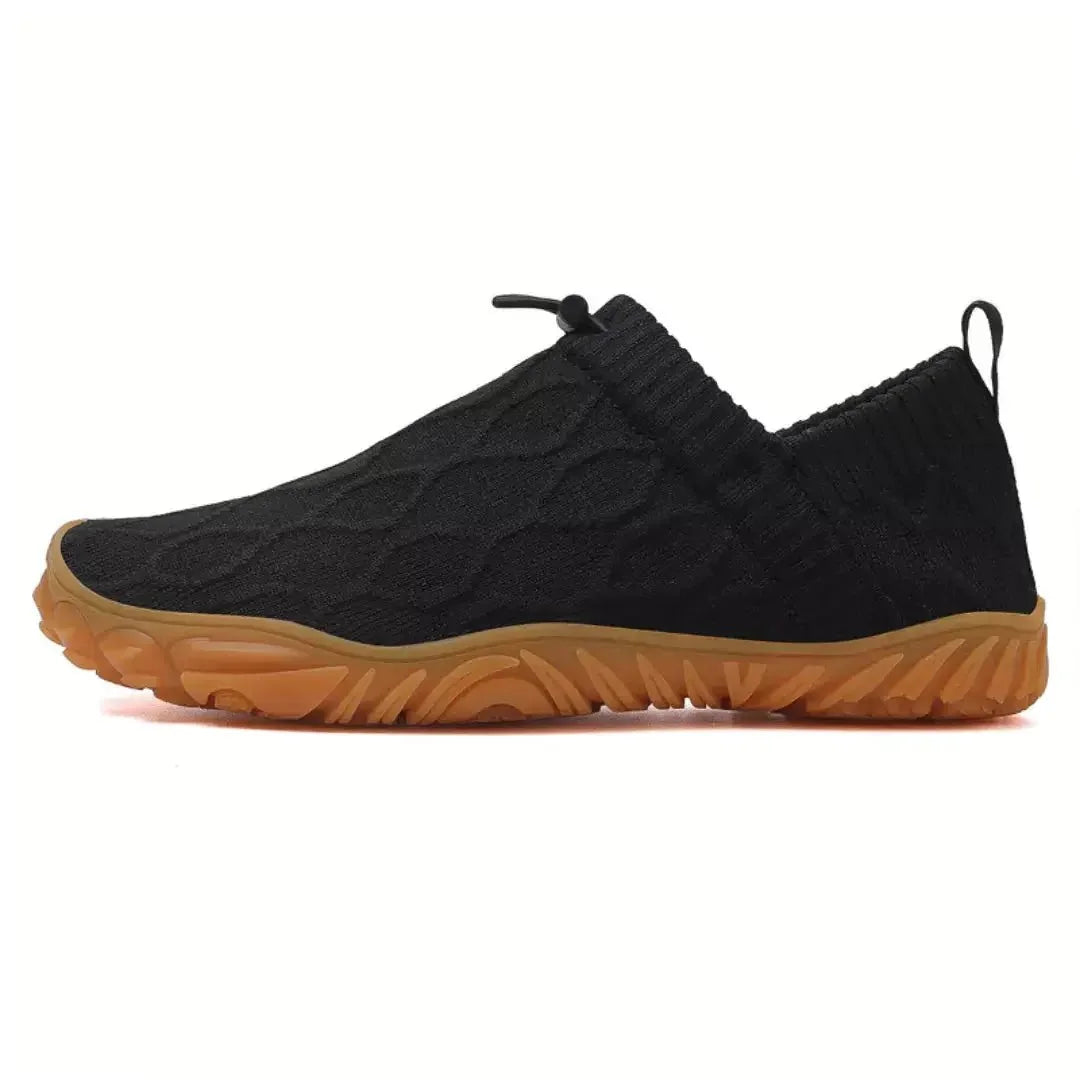 Black barefoot trainers, isolated side studio view