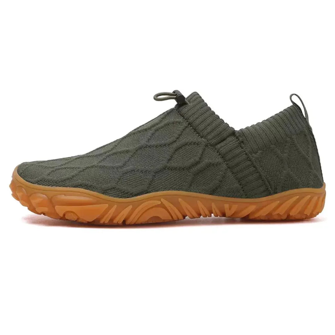 Dark green barefoot-style shoes, isolated side studio view